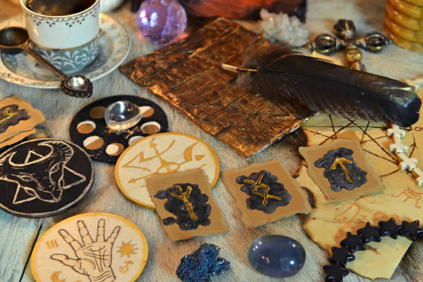 istock Runes, sacred symbols, crystals and magic ritual objects on witch table. 1304822667