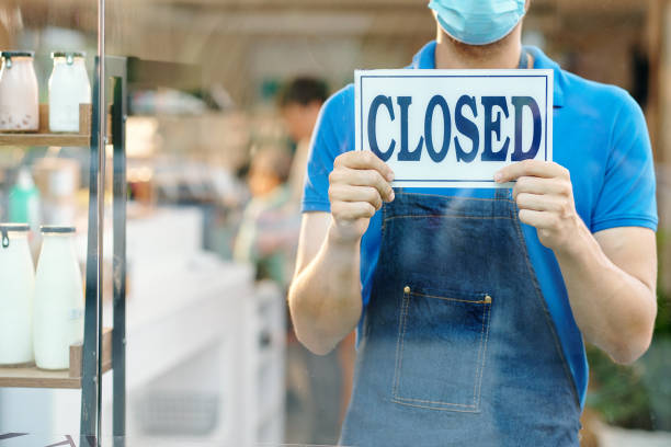 istock Waiter showing closed sign 1304826177