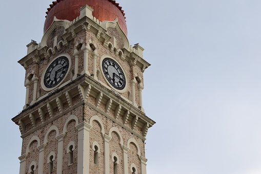 The close-up of the clock tower, the highest point of the Sultan Abdul Samad Building in Kuala Lumpur, Malaysia.