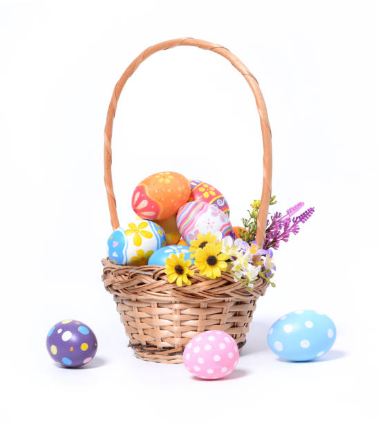 istock Happy Easter day colorful eggs in basket with flowers isolated on white background 1304828156
