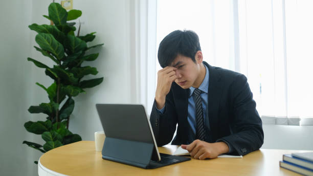istock Exhausted businessman feeling tired and suffering from eye strain after long computer tablet use. 1304832363