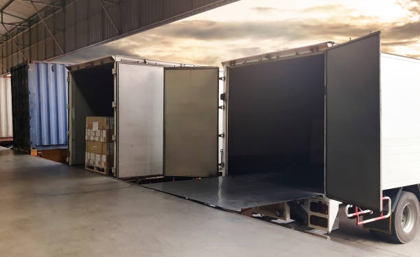 istock Cargo Container Truck Parked Loading at Dock Warehouse. Cargo Shipment. Industry Freight Truck Transportation. Logistics 1304837233