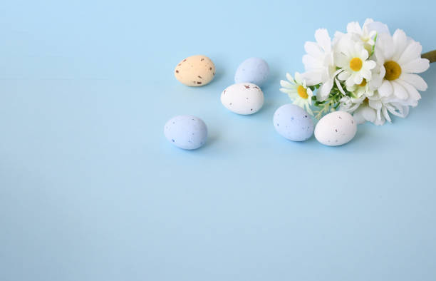 istock Easter background with bouquet white flwoer and easter eggs in soft color on blue sky background decorate and text copy space, happy and funny season in april 1304837904