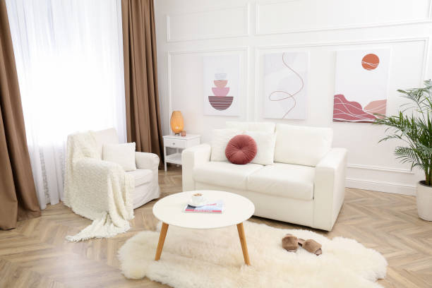 istock Stylish living room interior with comfortable sofa and pictures 1304839017