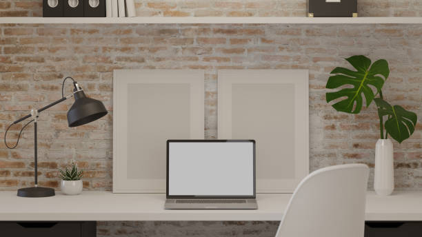 istock 3D rendering, home office room with laptop, mock up frame, decorations and supplies on the table with brick wall, 3D illustration 1304842164