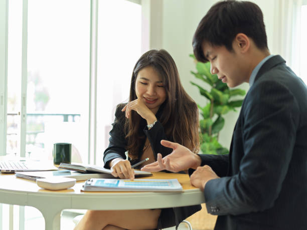 istock Businesspeople talking to each other while discussing on their work 1304842188