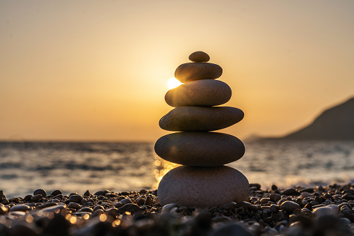 Balanced stones on a pebble beach during sunset. Kaputas beach, Antalya, Turkey