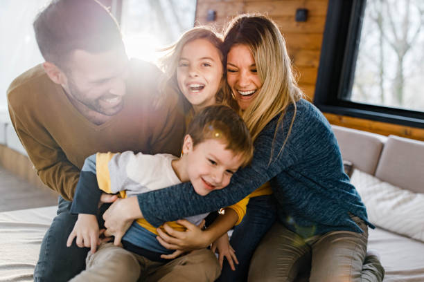 istock Cheerful family having fun while playing on sofa in the living room. 1304847125