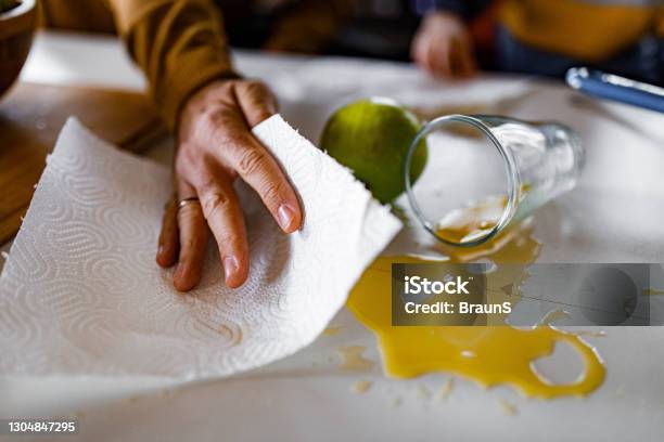 Cleaning Spilled Orange Juice Stock Photo - Download Image Now - Spilling, Cleaning, Juice - Drink