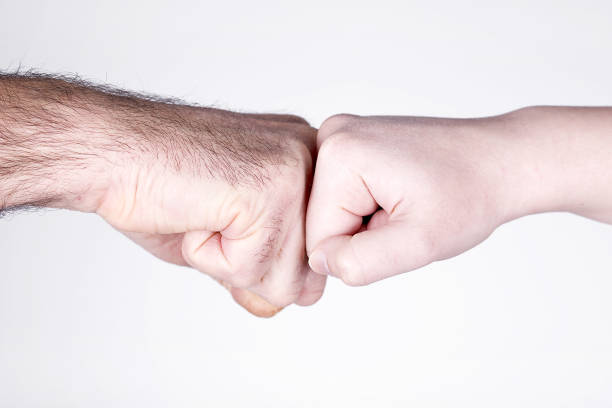 istock Man and woman striking fists 1304847356