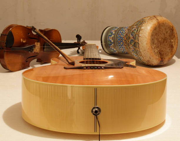 istock Guitar Bongo and violin are ready to play on the table 1304848080