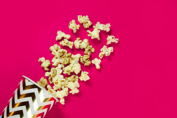 istock paper cup with scattered popcorn, mock up 1304848433