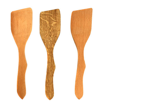 istock Wooden kitchen spatulas isolated on white background 1304848525