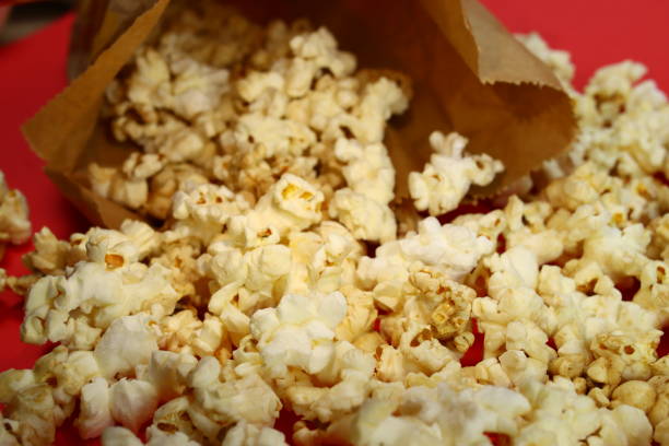 istock Caramel popcorn spilling out of a paper bag 1304848532
