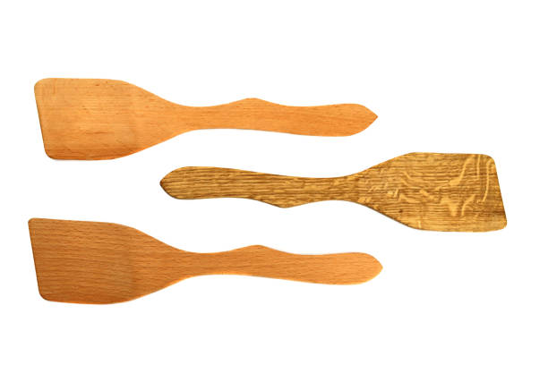 istock Wooden kitchen spatulas isolated on white background 1304848567