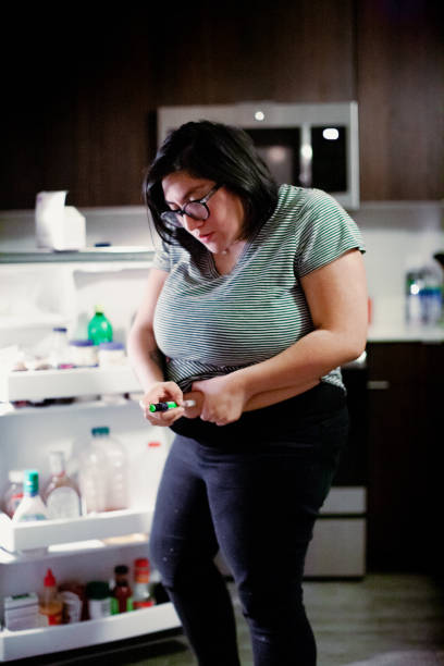 istock Hispanic Woman Injecting Herself with Insulin 1304848612