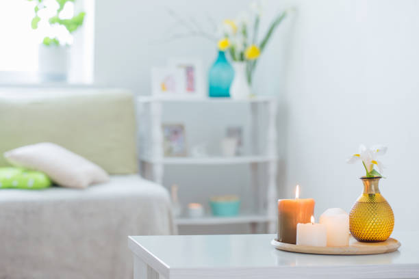 Aroma lamp with burning candle and essential oil on wooden table