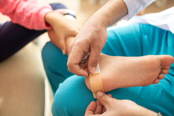 istock Hand putting a plaster on wounded heel to doctor 1304849486