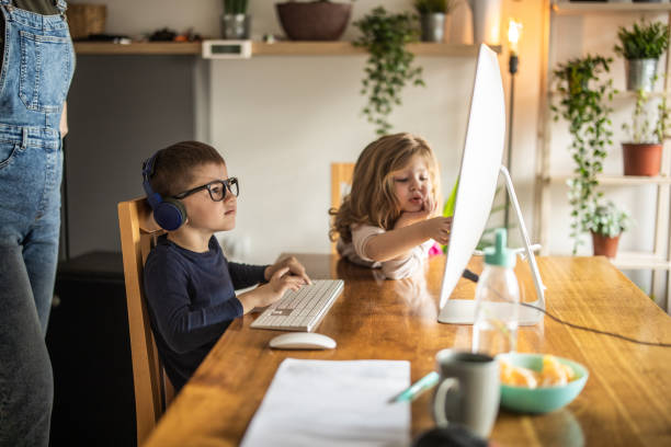 istock Mother helping her son with homeschooling 1304849743