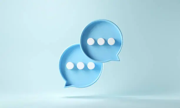 Photo of Two bubble talk or comment sign symbol on blue background.