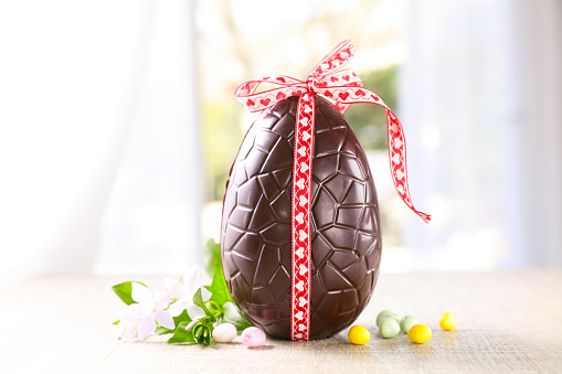chocolate easter egg with ribbon and flower