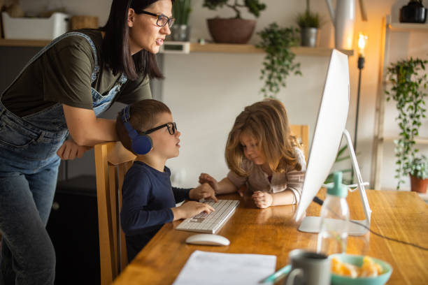 istock Mother helping her son with homeschooling 1304850939