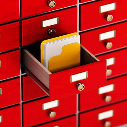 Yellow folder with documents inside the open red catalogue drawer.