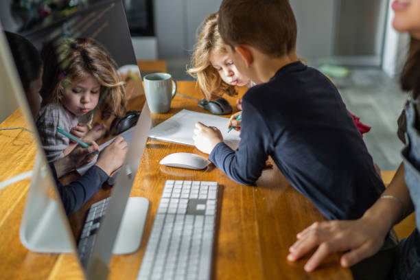 istock Mother working from home with two kids beside her 1304852903