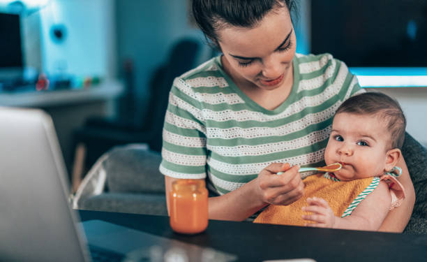 istock Mother feeding her baby 1304853431