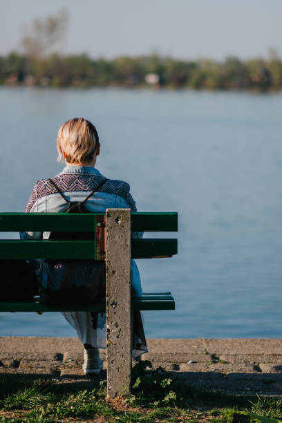 istock A young lonely woman sitting on the bench 1304853660
