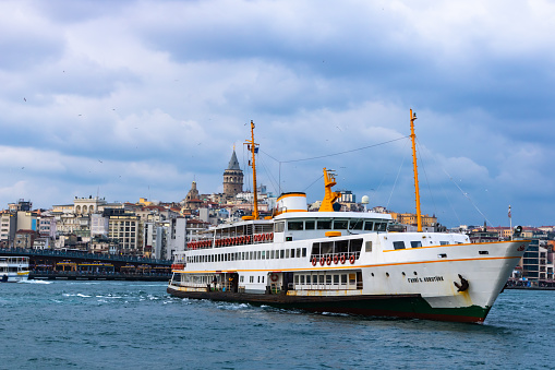 Istanbul turkey - 2.22.2020: Ferry and Galata Tower in Istanbul. Istanbul background photo.