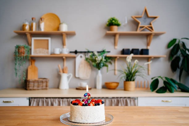 Beautiful modern kitchen. There is a birthday cake on the work surface
