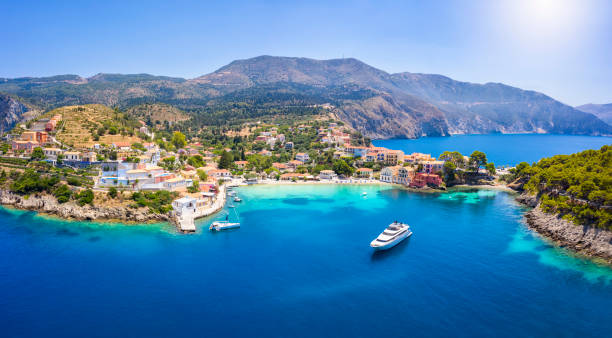 Aerial view to the beautiful fishing village of Assos on the island of Kefalonia, Greece Aerial view to the beautiful fishing village of Assos on the island of Kefalonia, Greece, surrounded by turquoise sea and green hills with Pine Trees kefalonia stock pictures, royalty-free photos & images