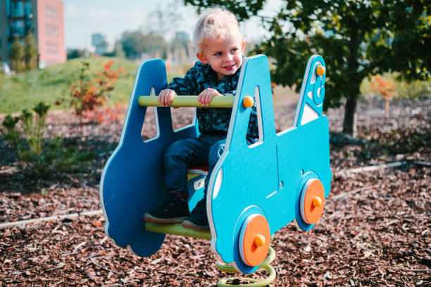 istock Young toddler boy playing at children playground. 1304857717