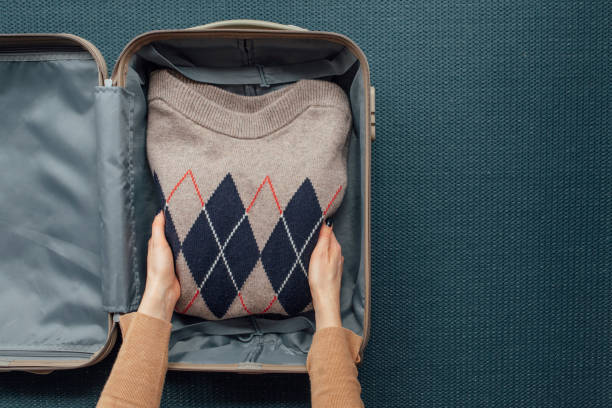 istock A Woman Packing her Clothes in a Suitcase (Copy Space) 1304857740