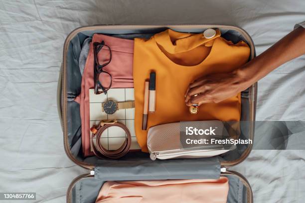 A Woman Packing Her Clothes In A Suitcase Stock Photo - Download Image Now - Suitcase, Packing, Travel