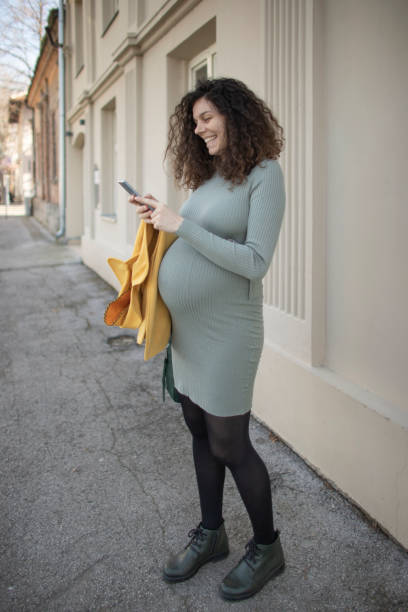istock Pregnant woman using a smart phone 1304859604