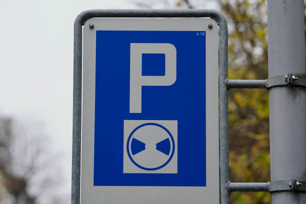 istock Traffic sign parking disc with tree in the background. 1304861432