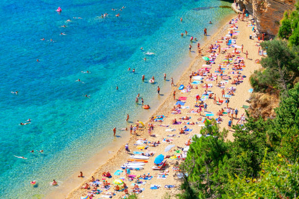 istock Crowd of people resting on the sandy beach 1304861883