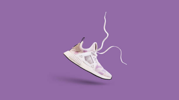 Object pattern-sneakers Pattern made of many white trendy sneakers on purple pastel background shoes stock pictures, royalty-free photos & images