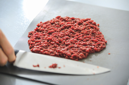 Horsemeat finely chopped using sharp knife, preparing steak tartare, or minced steak