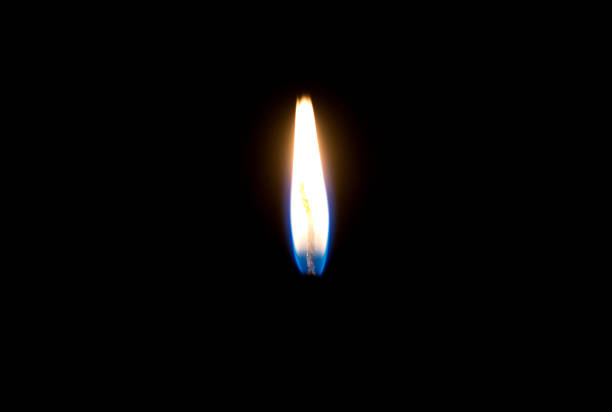 flames burning in the dark candle. close-up against a dark background.
