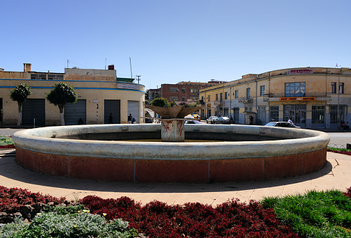 Asmara, Eritrea: fountain and roundabout, intersection of Mereb Street and Sematat Avenue, the colonial Via Ugo di Fazio and Viale de Bono, near FIAT Tagliero - Italian art deco facades in the background.