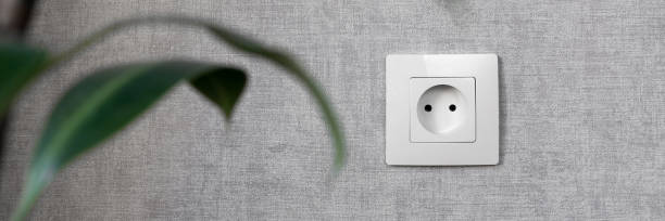 istock Electrical outlet on the gray wall. Electricity, safety, energy saving concept. 1304870177