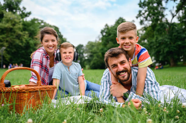 istock Happy family lying down on grass in the park 1304870448
