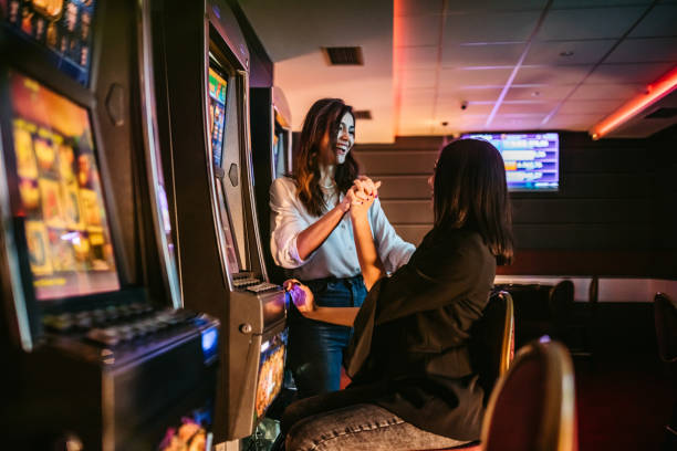 istock Friends playing on slot machines 1304871678