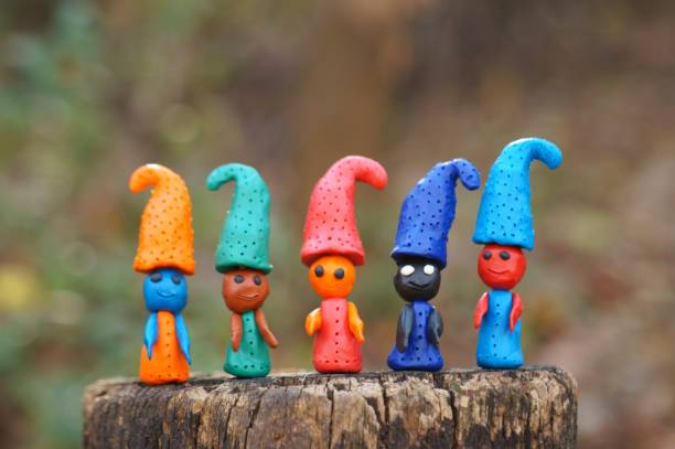 istock Figures of multi-colored gnomes on a colored background. 1304873147
