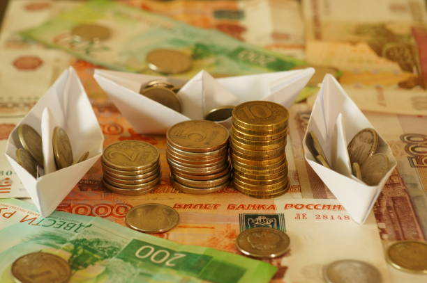 istock Several paper boats loaded with coins. 1304873165