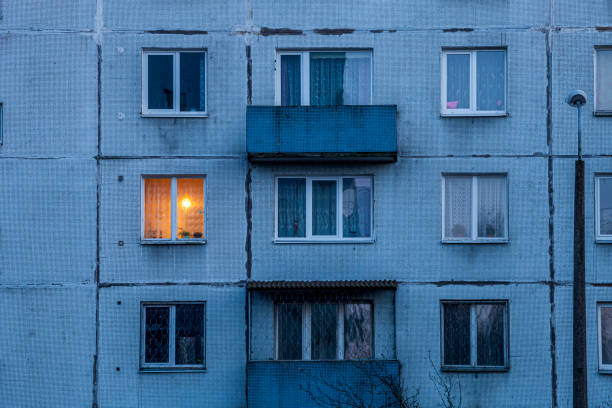 istock Wall of multi-storey residential building with Iluminated window 1304874979