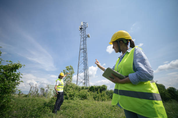 istock Engineers working on the field near a Telecommunications tower. Teamwork. 1304876055